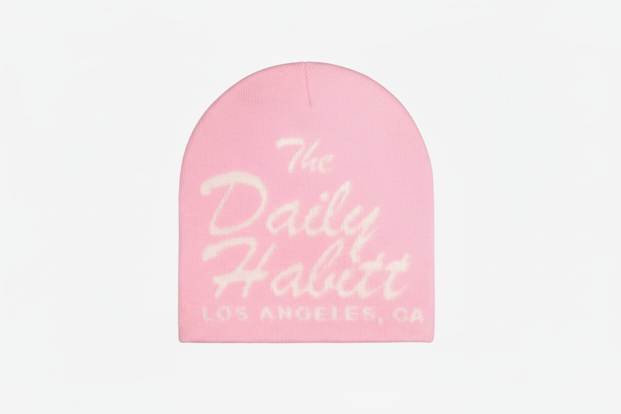 Pink beanie with 'The Daily Habit' text on a white background
